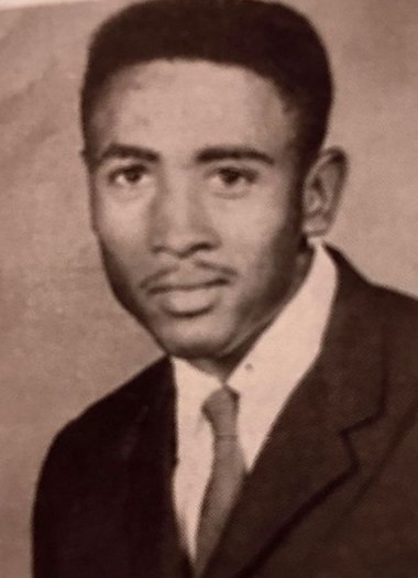 a young man poses for a yearbook photo