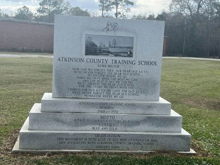 The front of the monument. Engraved are the school song, the school motto, colors, and a dedication.