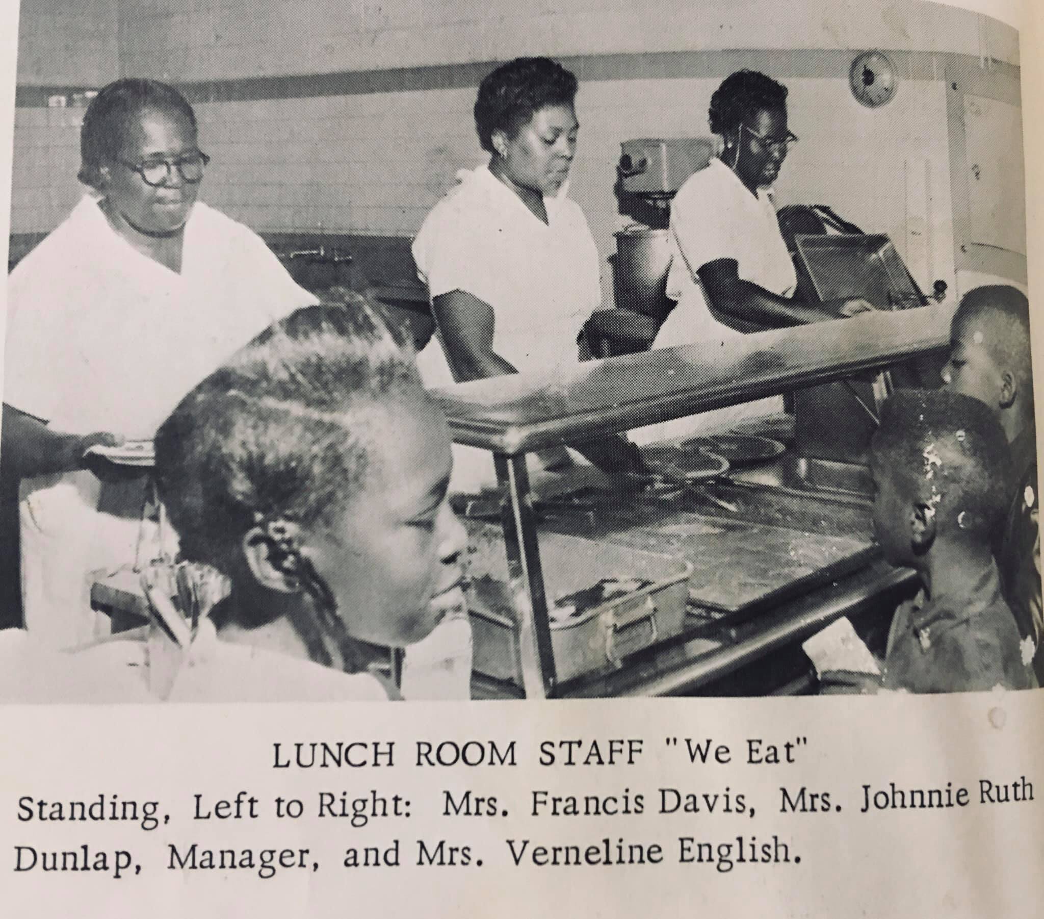 Lunch room staff members serve students lunch in the lunchroom.